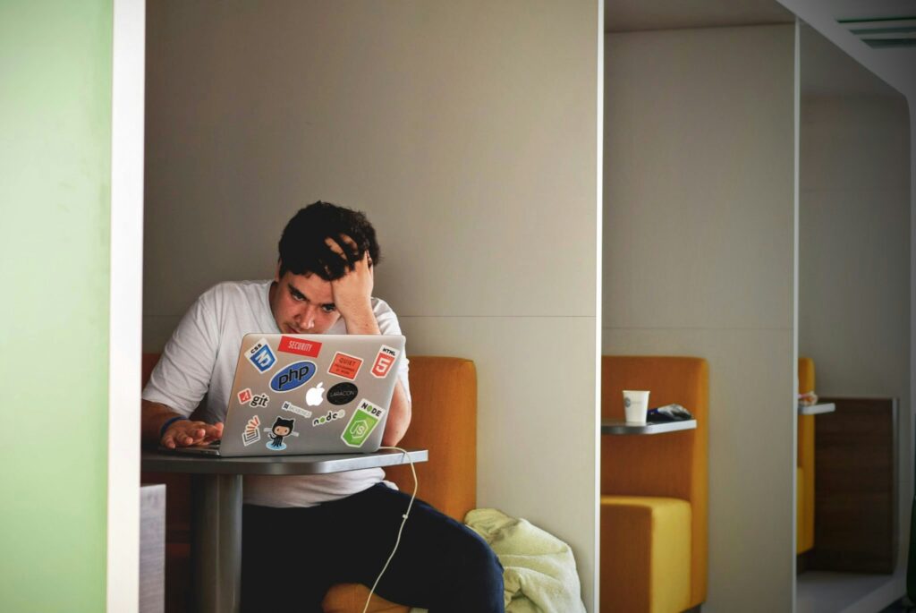 A man is stressed sitting at his computer.
