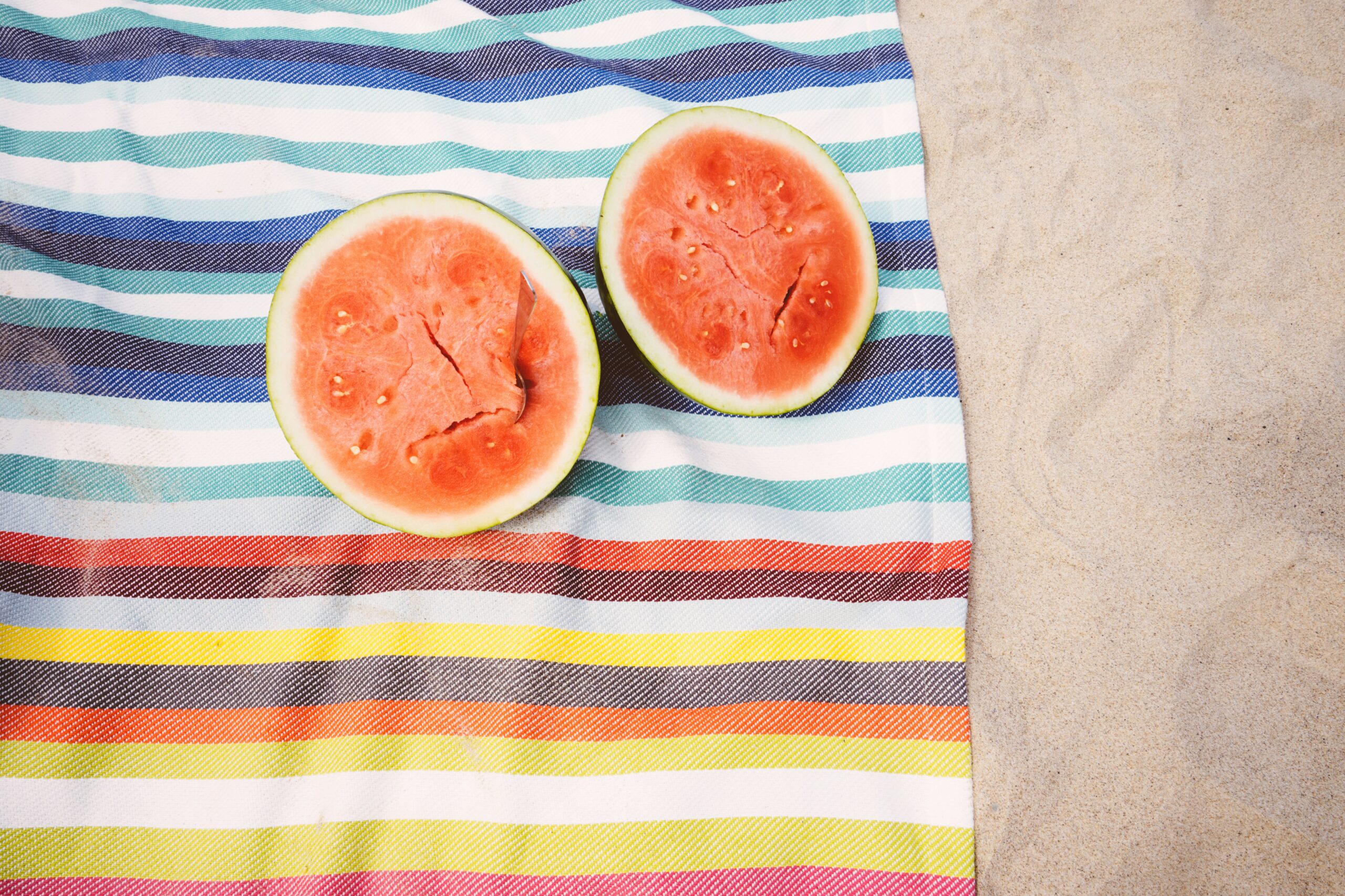 Watermelon on top of a beach towel